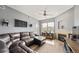 Cozy living room featuring a fireplace, hardwood floors, and ample natural light at 10787 Twenty Mile Rd # 205, Parker, CO 80134