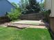 A green backyard features grass and a patio with landscaping in a fenced yard at 19421 E Evans Dr, Aurora, CO 80013