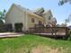 A sprawling backyard showcasing a wooden deck, lush green lawn, and mature trees at 19421 E Evans Dr, Aurora, CO 80013