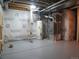 A spacious basement with mechanicals featuring a water heater and furnace at 19421 E Evans Dr, Aurora, CO 80013