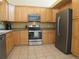 Well-equipped kitchen features stainless steel appliances, ample cabinets, and tile flooring at 19421 E Evans Dr, Aurora, CO 80013