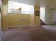 An inviting living room with neutral carpet and yellow walls, offering a cozy and spacious atmosphere at 19421 E Evans Dr, Aurora, CO 80013