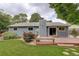 A spacious backyard featuring a wooden deck, well-kept lawn, and privacy landscaping at 10883 Otis Cir, Westminster, CO 80020