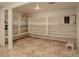 Spacious basement area with tile flooring and ample shelving for storage at 10883 Otis Cir, Westminster, CO 80020
