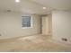 Bright basement with carpet, window, and an open doorway at 10883 Otis Cir, Westminster, CO 80020