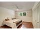 Comfortable bedroom with hardwood floors, ceiling fan, closet, and a sunlit window at 10883 Otis Cir, Westminster, CO 80020