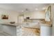 Bright eat-in kitchen featuring white cabinets, granite countertops, and modern appliances at 10883 Otis Cir, Westminster, CO 80020