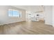 Open living room with vinyl plank flooring and large window at 17771 E 93Rd Ave, Commerce City, CO 80022