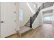 Modern staircase with dark wood railing and carpet at 17771 E 93Rd Ave, Commerce City, CO 80022