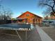 Backyard with a trampoline and a charming wood house with a screened porch at 2602 Jasmine St, Denver, CO 80207