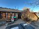 Charming backyard featuring a wood patio, a scooter, and various plants at 2602 Jasmine St, Denver, CO 80207