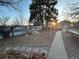 Spacious backyard with a stone path, garden beds, and a metal fence at 2602 Jasmine St, Denver, CO 80207