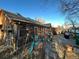 Backyard with a screened-in porch, stone patio, and various plants and décor at 2602 Jasmine St, Denver, CO 80207