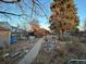 Landscaped backyard with a stone pathway leading to the house and garden beds at 2602 Jasmine St, Denver, CO 80207