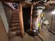 Unfinished basement with concrete walls and steps, featuring a water heater at 2602 Jasmine St, Denver, CO 80207