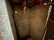 Unfinished basement featuring concrete block walls and a dark corner at 2602 Jasmine St, Denver, CO 80207