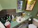 Well-lit bathroom with sink, countertop, stained glass window, and ample storage space at 2602 Jasmine St, Denver, CO 80207