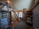 Unique bedroom featuring a lofted bed accessed by a spiral staircase and exposed brick wall at 2602 Jasmine St, Denver, CO 80207