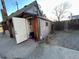 Exterior view of the home showcasing a small yard and access to the side entrance at 2602 Jasmine St, Denver, CO 80207
