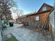 Exterior view of house featuring a stone patio, wood siding, and beautiful landscaping, offering a serene retreat at 2602 Jasmine St, Denver, CO 80207