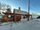 Exterior side view of a wooden home with a chimney and updated roof at 2602 Jasmine St, Denver, CO 80207
