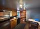 Efficient kitchen featuring stainless steel appliances, gas range, and convenient breakfast bar at 2602 Jasmine St, Denver, CO 80207