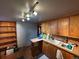Well-lit kitchen with wood cabinets, breakfast bar, shelving, and plenty of countertop space at 2602 Jasmine St, Denver, CO 80207
