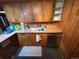 Cozy kitchen with wooden cabinets, stainless steel dishwasher, and functional layout at 2602 Jasmine St, Denver, CO 80207