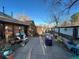 Backyard patio with a scooter, a garbage can and potted plants at 2602 Jasmine St, Denver, CO 80207