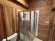 Compact shower with wooden walls and a glass door, complete with towel racks and ample space at 2602 Jasmine St, Denver, CO 80207