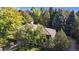 Aerial view of a home with a brown roof surrounded by mature trees, offering privacy and shade at 5432 S Dayton Ct, Greenwood Village, CO 80111