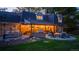 Expansive brick backyard patio featuring an outdoor kitchen, dining area, seating, and a cozy fire pit at 5432 S Dayton Ct, Greenwood Village, CO 80111