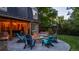 Brick patio with a fire pit, comfortable seating, and a beautifully landscaped yard creates an ideal outdoor living space at 5432 S Dayton Ct, Greenwood Village, CO 80111