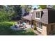 Aerial view of backyard featuring an outdoor kitchen, patio with a fire pit, and a well-maintained lawn at 5432 S Dayton Ct, Greenwood Village, CO 80111