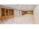 Finished basement offering built-in wooden cabinets, wood-look tile flooring and a kitchenette area at 5432 S Dayton Ct, Greenwood Village, CO 80111
