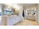 Bright bathroom featuring double sinks, a glass shower, and tile flooring at 5432 S Dayton Ct, Greenwood Village, CO 80111