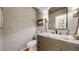 Chic powder room with a marble countertop, modern fixtures, and elegant wallpaper at 5432 S Dayton Ct, Greenwood Village, CO 80111