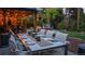 Inviting outdoor dining area with a table set for eight, under the soft glow of string lights at 5432 S Dayton Ct, Greenwood Village, CO 80111