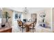 Bright dining room features a rustic table, modern lighting, and a large window that provides plenty of natural light at 5432 S Dayton Ct, Greenwood Village, CO 80111