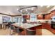 Spacious kitchen with granite countertops, cherry cabinets, stainless steel appliances, and breakfast bar seating at 5432 S Dayton Ct, Greenwood Village, CO 80111