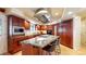 Modern kitchen featuring an oversized island with seating, cherry cabinets, and built in stainless steel appliances at 5432 S Dayton Ct, Greenwood Village, CO 80111