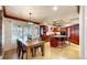 Bright, open kitchen and dining area with stainless steel appliances, cherry cabinets and hardwood floors at 5432 S Dayton Ct, Greenwood Village, CO 80111