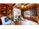 Luxurious office with custom built-ins, hardwood floors, ample natural light, and a seating area at 5432 S Dayton Ct, Greenwood Village, CO 80111