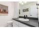 Stylish half bathroom with modern fixtures, decorative wall art, and contemporary design at 1633 S Trenton St, Denver, CO 80231