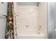Compact bathroom with white tile, a bathtub, and a classic shower head at 1633 S Trenton St, Denver, CO 80231