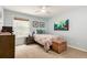 Sunlit bedroom with bed, side table, and dresser, offering a calm and inviting space at 1633 S Trenton St, Denver, CO 80231