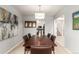 Elegant dining room with a large wooden table, leather chairs, and modern artwork at 1633 S Trenton St, Denver, CO 80231
