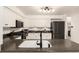 Kitchen featuring white cabinets, black countertops and appliances, and stainless-steel fixtures at 1633 S Trenton St, Denver, CO 80231
