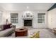 Comfortable living room with a cozy fireplace and an abundance of natural light at 1633 S Trenton St, Denver, CO 80231