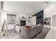 Bright living room with fireplace, large windows, modern furnishings, and neutral decor at 1633 S Trenton St, Denver, CO 80231